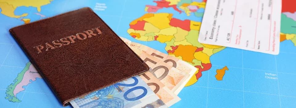 Passport with euro banknotes and boarding pass on world map, illustrating Canada to Sweden – Bonnie’s story of international relocation and new beginnings.