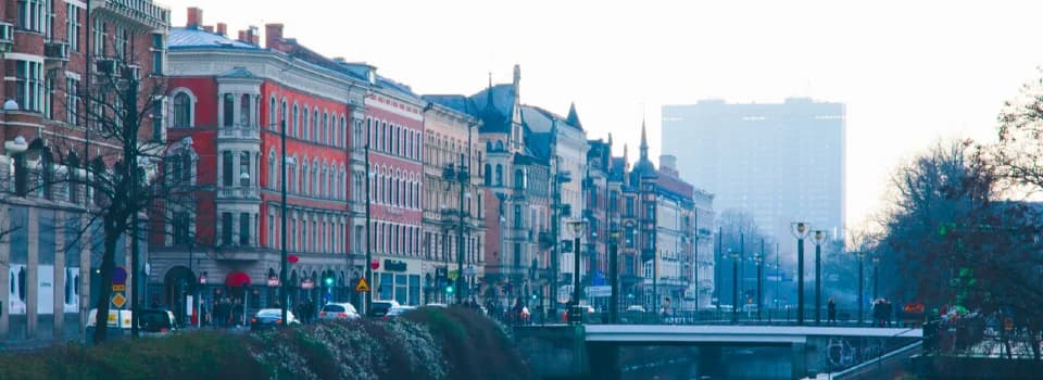 Colorful Swedish city street with historic buildings and canal, illustrating Moving from Syria to Sweden – Mahmoud’s story of starting a new life.