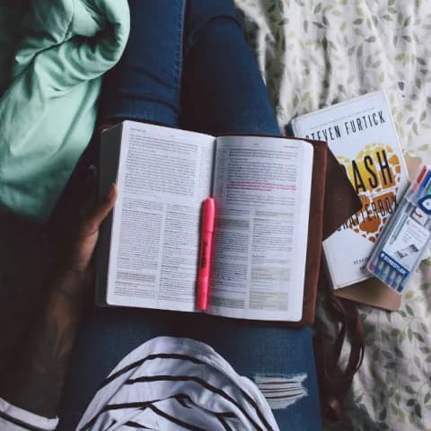 Learn Swedish at home with laptop, books, and headphones
