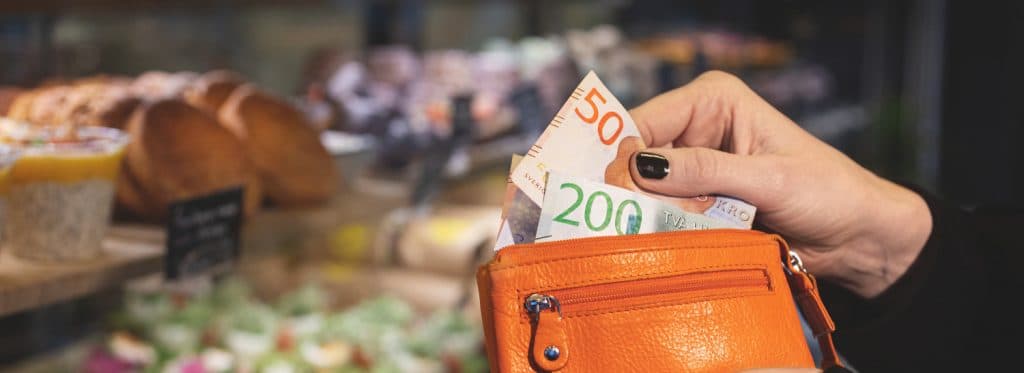 Wallet with Swedish banknotes, symbol of inkassokrav