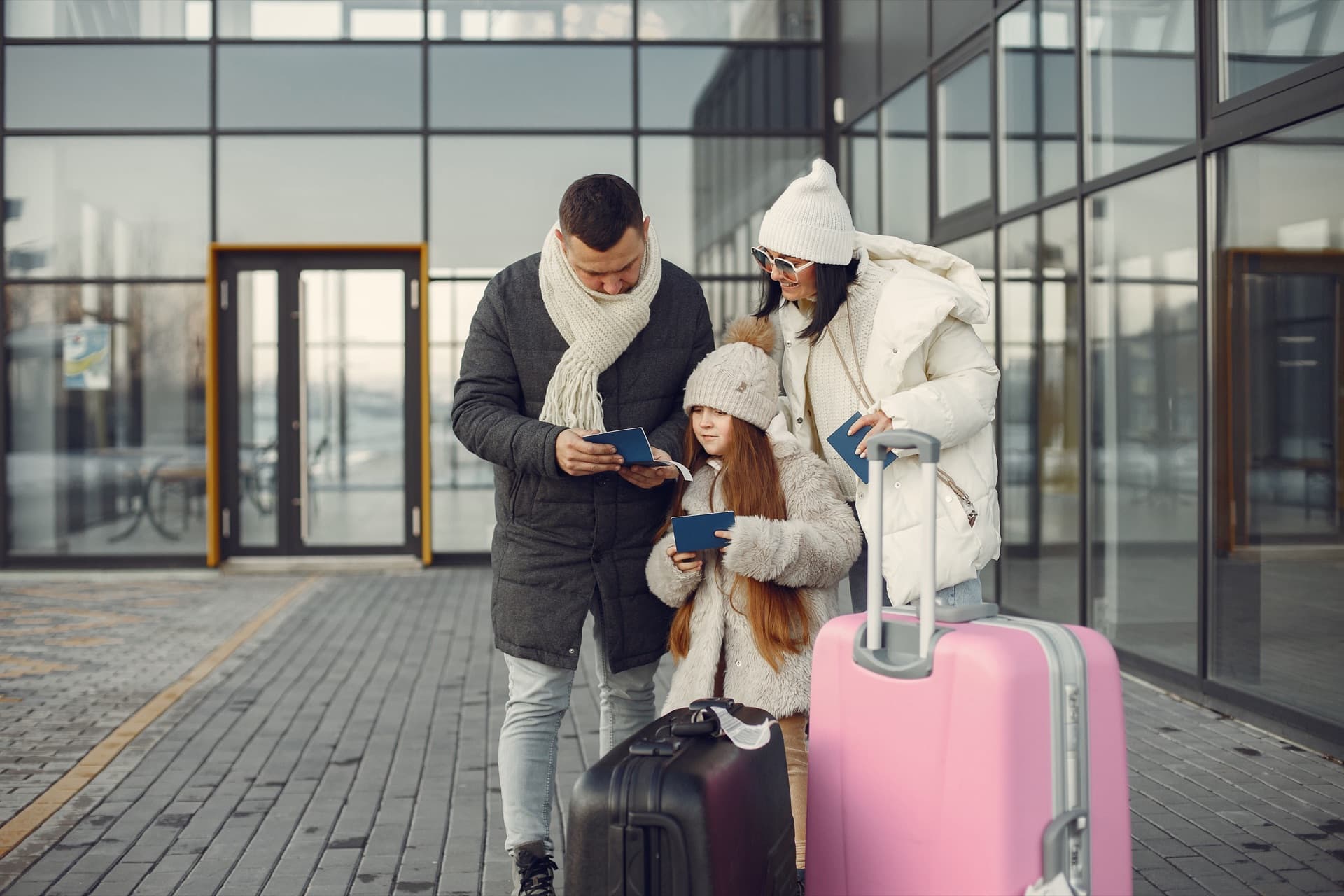 Family with luggage checking their passports before moving to Sweden